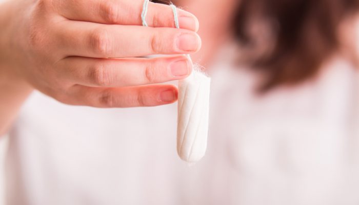 Woman holding a tampon - close up